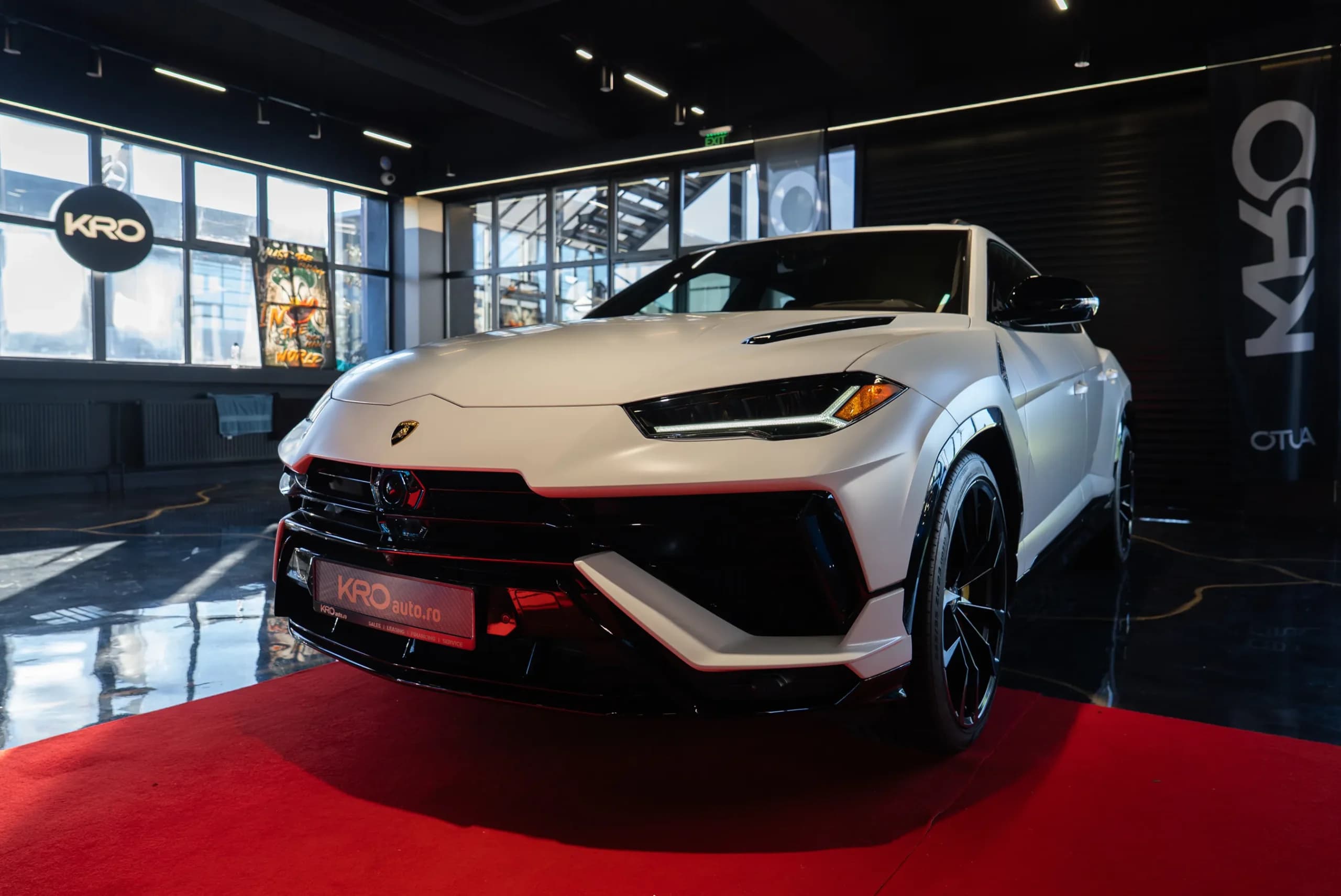 White Lamborghini Urus S on a red carpet inside the KRO showroom