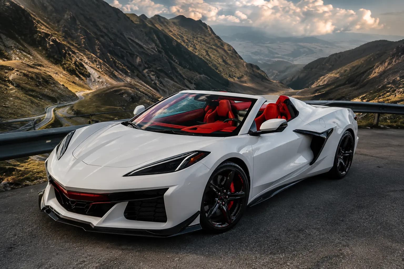 White Chevrolet Corvette Z06 Convertible at a lookout above a winding mountain pass